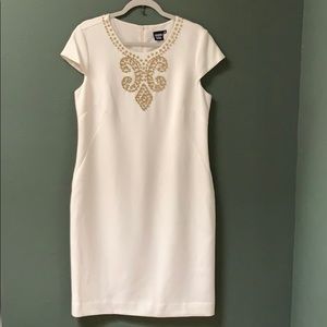 Light cream colored dress with embellishment.